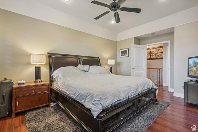 bedroom featuring wood finished floors, baseboards, and ceiling fan
