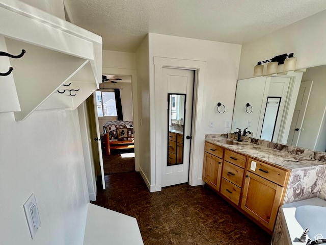 640 S 100 E, Mantua, UT 84324 - bathroom featuring vanity, a ceiling fan, a bathing tub, and a textured ceiling