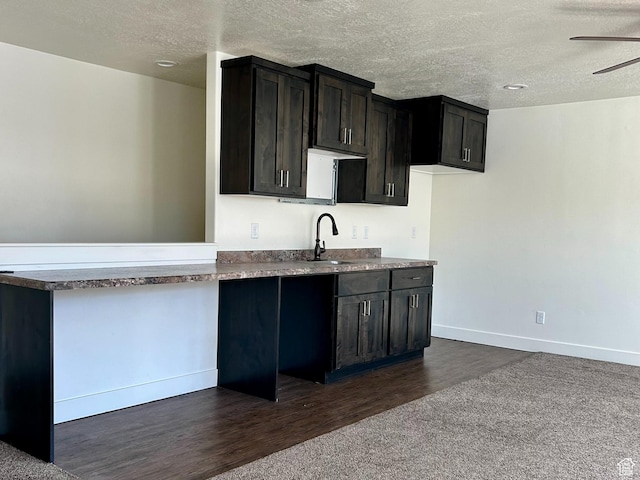 640 S 100 E, Mantua, UT 84324 - kitchen featuring dark wood-style floors, baseboards, a sink, ceiling fan, and a textured ceiling