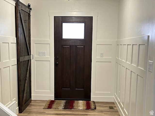 640 S 100 E, Mantua, UT 84324 - entrance foyer featuring a decorative wall, visible vents, a barn door, and wood finished floors