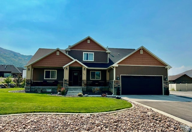 640 S 100 E, Mantua, UT 84324 - craftsman-style house with a porch, an attached garage, concrete driveway, a front lawn, and stone siding