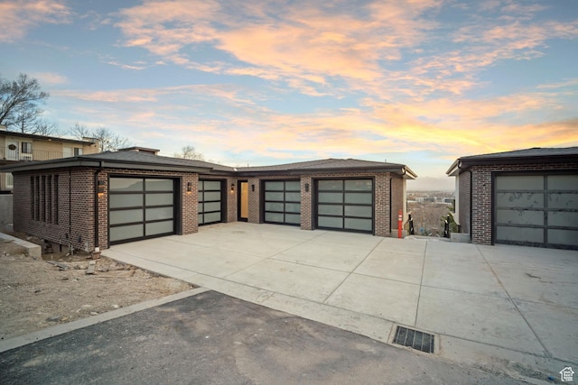 garage featuring visible vents and concrete driveway