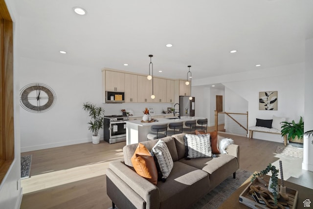 603 N Darwin St E Unit 10, Salt Lake City, UT 84103 - living room featuring visible vents, recessed lighting, light wood-type flooring, and baseboards