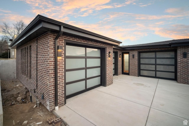 603 N Darwin St E Unit 10, Salt Lake City, UT 84103 - garage at dusk with concrete driveway