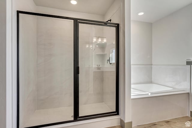 full bath with a shower stall, a garden tub, and recessed lighting