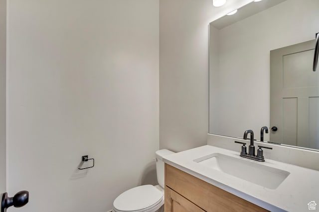bathroom with toilet and vanity