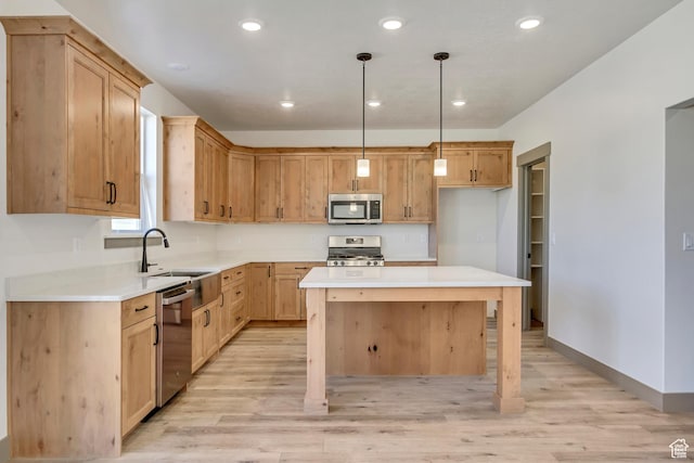 kitchen with recessed lighting, light wood-style floors, appliances with stainless steel finishes, and a sink