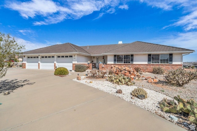 976 N Quail Ridge Dr, Washington, UT 84780 - ranch-style home with an attached garage, brick siding, and driveway