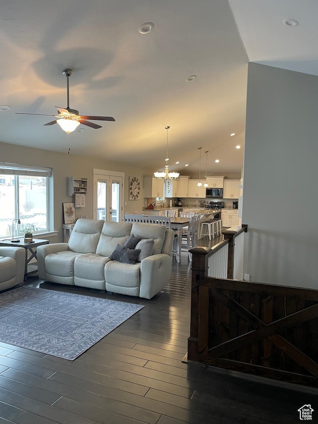 living room with recessed lighting, ceiling fan with notable chandelier, and dark wood-style flooring