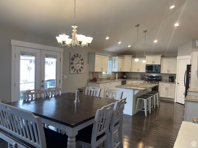 dining room with recessed lighting, french doors, an inviting chandelier, and dark wood finished floors