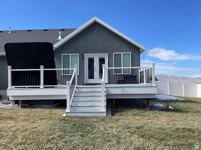 back of house with stairs, stucco siding, french doors, a yard, and a deck with mountain view