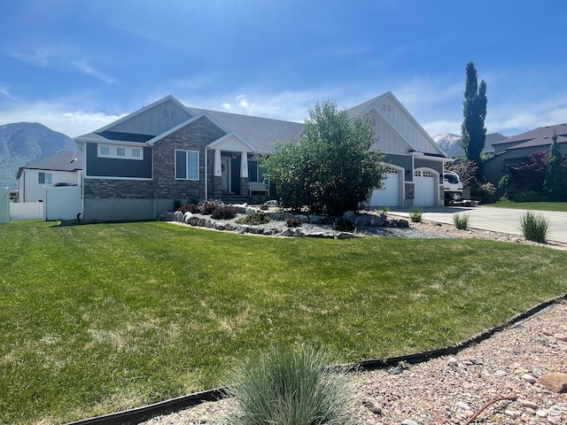 880 N Rocky Mountain Way, Elk Ridge, UT 84651 - craftsman house with board and batten siding, stone siding, concrete driveway, and an attached garage