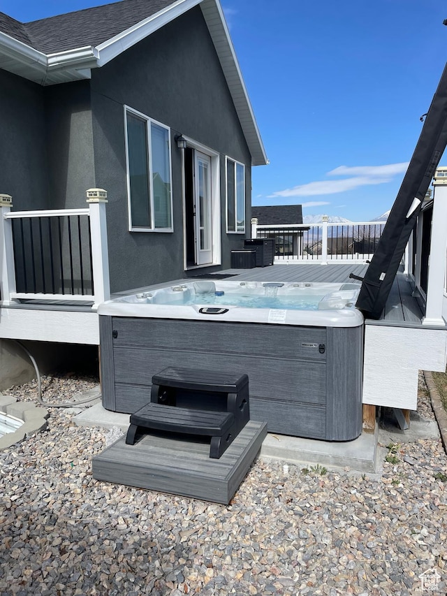 wooden terrace featuring a hot tub