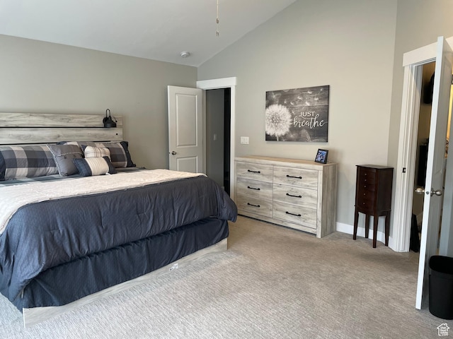 carpeted bedroom featuring lofted ceiling