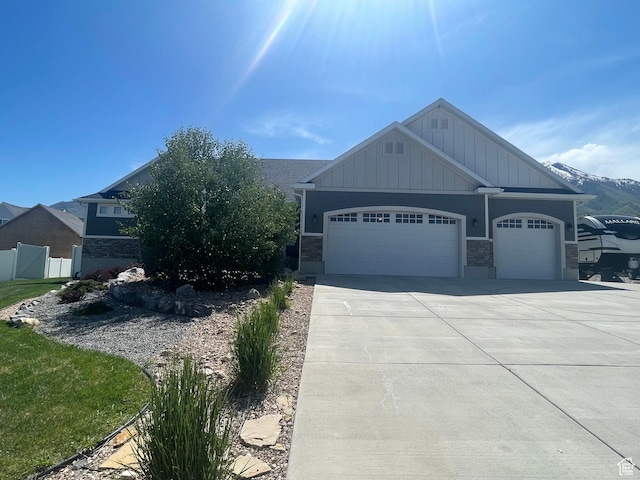 880 N Rocky Mountain Way, Elk Ridge, UT 84651 - view of front facade featuring board and batten siding, an attached garage, concrete driveway, and stone siding