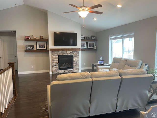 living area featuring dark wood-style floors, baseboards, lofted ceiling, a fireplace, and ceiling fan