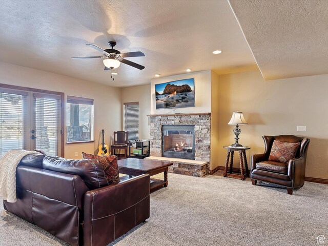 946 S Meadow Lark Ln E, Huntsville, UT 84317 - living area with a stone fireplace, a textured ceiling, carpet floors, and a ceiling fan