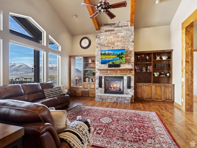 946 S Meadow Lark Ln E, Huntsville, UT 84317 - living area featuring high vaulted ceiling, a fireplace, wood finished floors, beamed ceiling, and ceiling fan