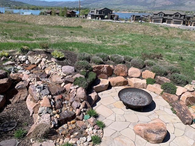 946 S Meadow Lark Ln E, Huntsville, UT 84317 - exterior space with a fire pit, a water and mountain view, and a patio area