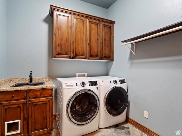 946 S Meadow Lark Ln E, Huntsville, UT 84317 - laundry area with baseboards, washer and dryer, cabinet space, and a sink