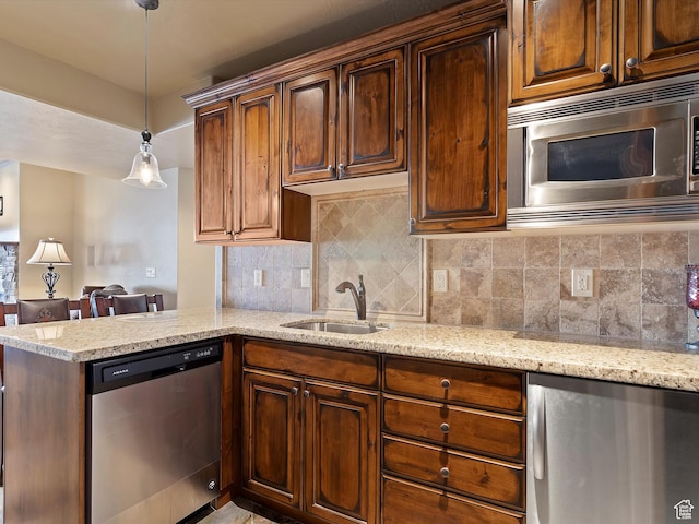 946 S Meadow Lark Ln E, Huntsville, UT 84317 - kitchen featuring light stone countertops, stainless steel appliances, tasteful backsplash, a sink, and hanging light fixtures