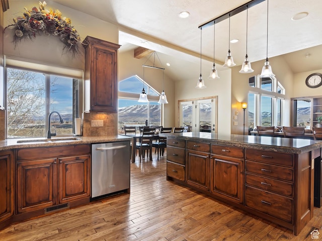 946 S Meadow Lark Ln E, Huntsville, UT 84317 - kitchen featuring a sink, tasteful backsplash, stainless steel dishwasher, visible vents, and hardwood / wood-style floors
