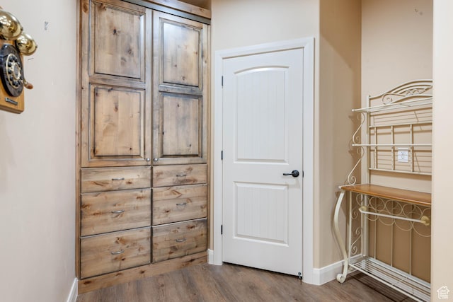 interior space with wood finished floors and baseboards