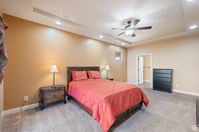 bedroom featuring a tray ceiling, recessed lighting, carpet, and baseboards
