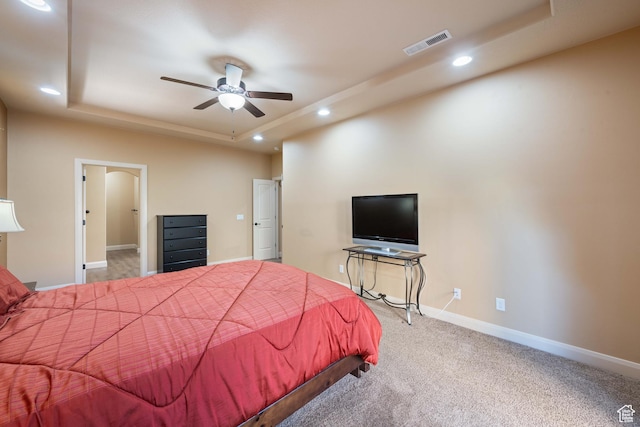 carpeted bedroom with visible vents, baseboards, ceiling fan, recessed lighting, and a raised ceiling