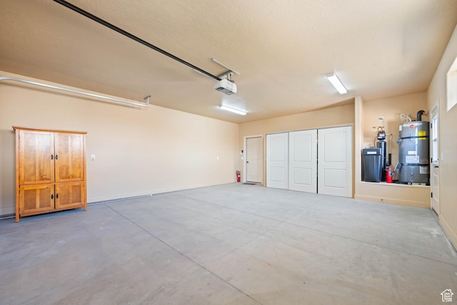 garage with strapped water heater and a garage door opener