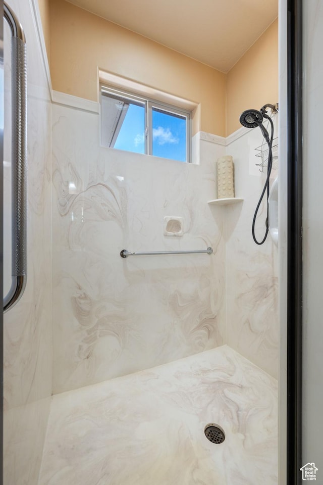 full bathroom featuring a marble finish shower