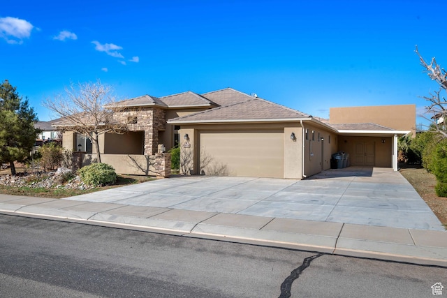 view of front of house featuring stucco siding, driveway, and a garage