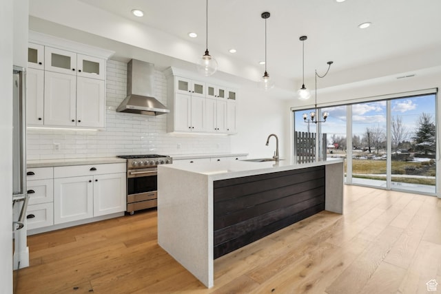1127 N 520 W Unit 40, Midway, UT 84049 - kitchen featuring wall chimney range hood, stainless steel appliances, a sink, recessed lighting, and decorative backsplash