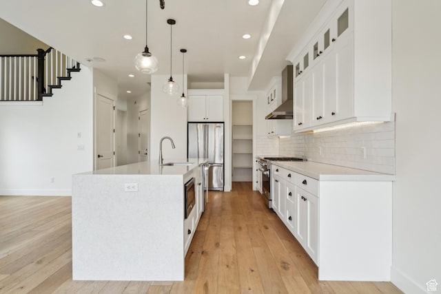 1127 N 520 W Unit 40, Midway, UT 84049 - kitchen featuring stainless steel appliances, a sink, recessed lighting, decorative backsplash, and light wood-type flooring