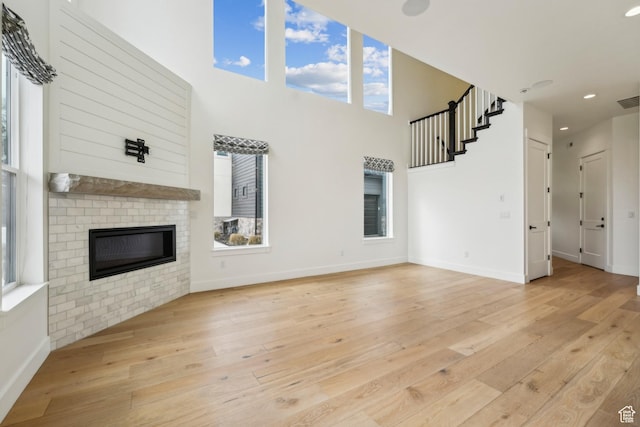 1127 N 520 W Unit 40, Midway, UT 84049 - unfurnished living room with light wood-style flooring, plenty of natural light, baseboards, a fireplace, and recessed lighting