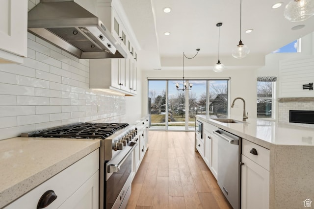 1127 N 520 W Unit 40, Midway, UT 84049 - kitchen featuring wall chimney exhaust hood, stainless steel appliances, plenty of natural light, tasteful backsplash, and recessed lighting