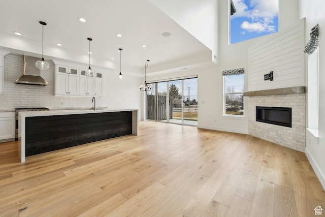 1127 N 520 W Unit 40, Midway, UT 84049 - unfurnished living room with a sink, a glass covered fireplace, light wood-style flooring, recessed lighting, and baseboards