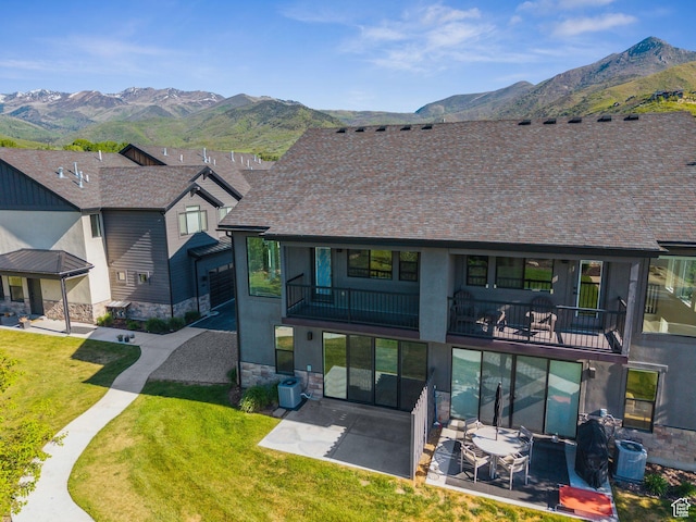 1127 N 520 W Unit 40, Midway, UT 84049 - back of house featuring a balcony, a mountain view, a patio, stone siding, and a yard