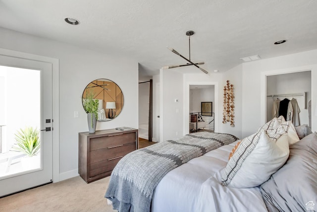bedroom featuring visible vents and light colored carpet