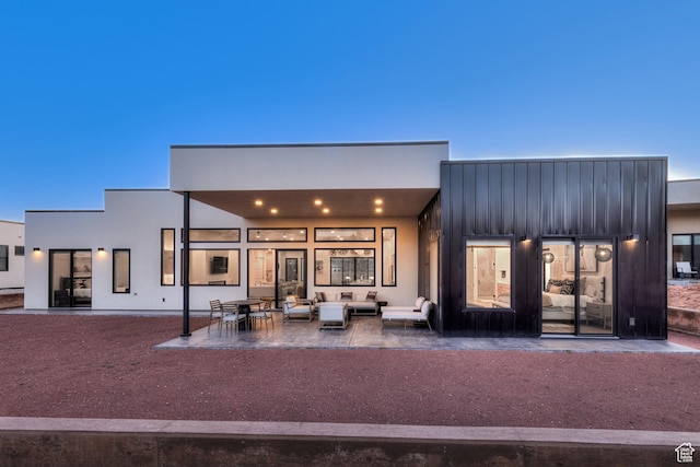 rear view of house featuring outdoor lounge area and a patio area