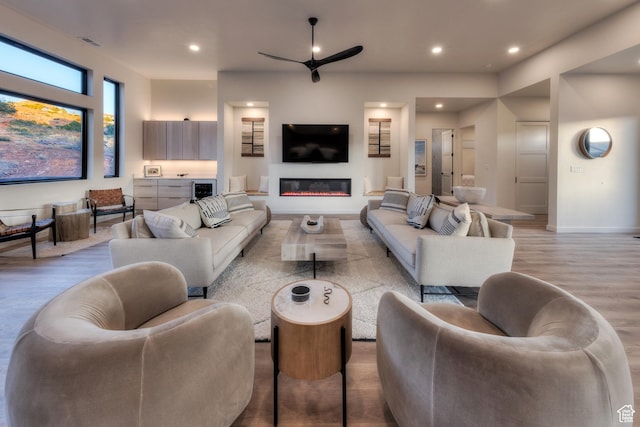 living room with visible vents, recessed lighting, ceiling fan, and wood finished floors