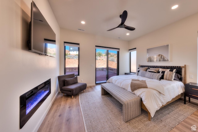 bedroom featuring access to outside, recessed lighting, light wood-style floors, and visible vents