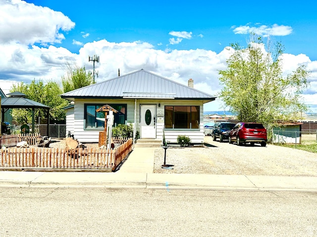 439 E 400 S, Vernal, UT 84078 - view of front of home featuring fence, a gazebo, a chimney, and metal roof