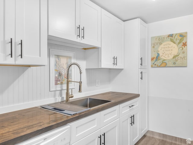 521 E 5th Ave Unit 605, Salt Lake City, UT 84103 - kitchen with a sink, white dishwasher, butcher block counters, and white cabinetry