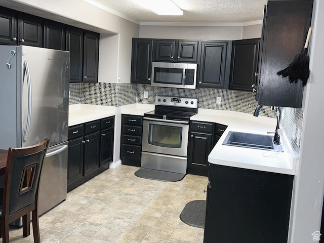 8196 N Cedar Springs Rd Unit 1, Eagle Mountain, UT 84005 - kitchen with stainless steel appliances, dark cabinetry, backsplash, a textured ceiling, and crown molding