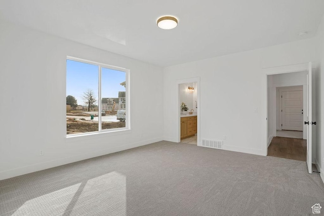 2878 W 2850 S, West Haven, UT 84401 - unfurnished bedroom with baseboards, visible vents, and light carpet