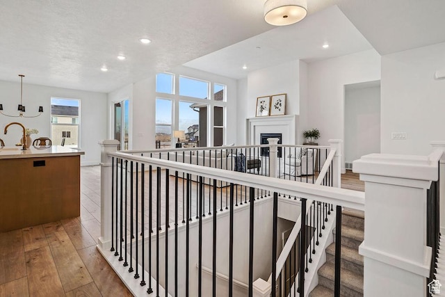 2878 W 2850 S, West Haven, UT 84401 - stairs featuring recessed lighting, a textured ceiling, baseboards, and hardwood / wood-style flooring