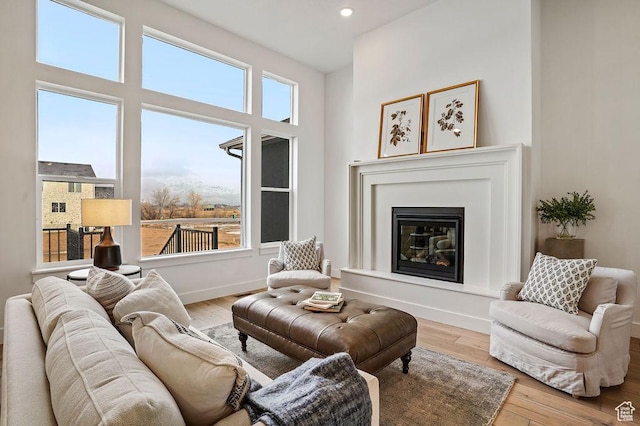 2878 W 2850 S, West Haven, UT 84401 - living room featuring a glass covered fireplace, recessed lighting, wood finished floors, and baseboards