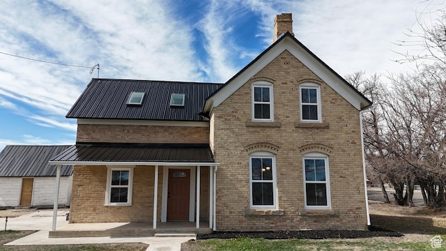 120 S 200 E, Castle Dale, UT 84513 - view of front of property with a porch, a chimney, brick siding, and metal roof