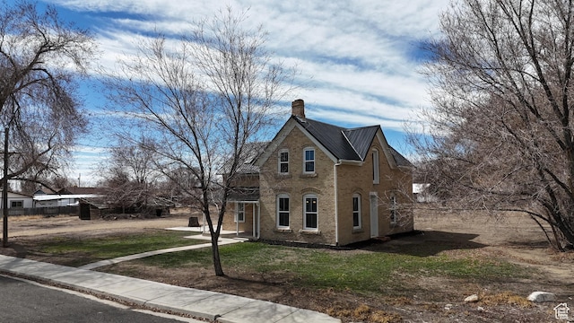 120 S 200 E, Castle Dale, UT 84513 - view of front of house with brick siding, a chimney, and a front yard